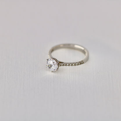 Six claw solitaire with diamonds in band