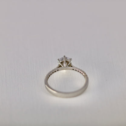 Six claw solitaire with diamonds in band
